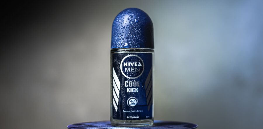 Primer plano del desodorante Nivea Men Cool Kick con gotas de agua sobre un fondo borroso.