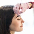 El maestro puso pintura negra con un pincel en las cejas de las modelos.