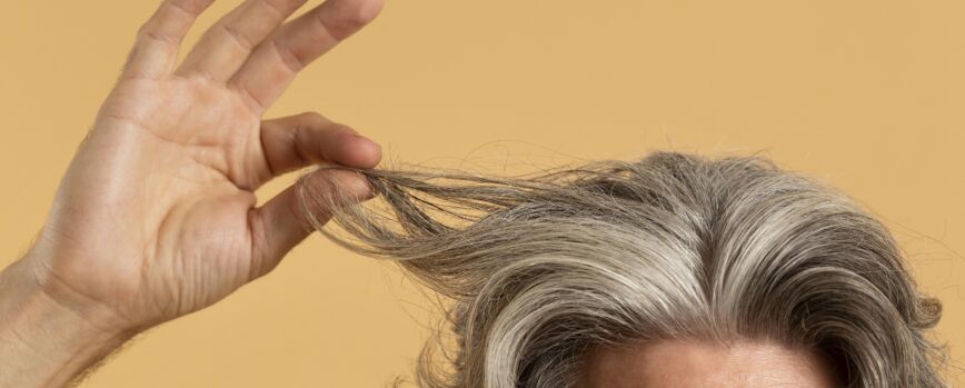 Anciano sosteniendo su cabello gris