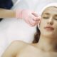 Mujer disfrutando de un relajante tratamiento facial en un entorno de spa sereno, promoviendo la relajación y la belleza.