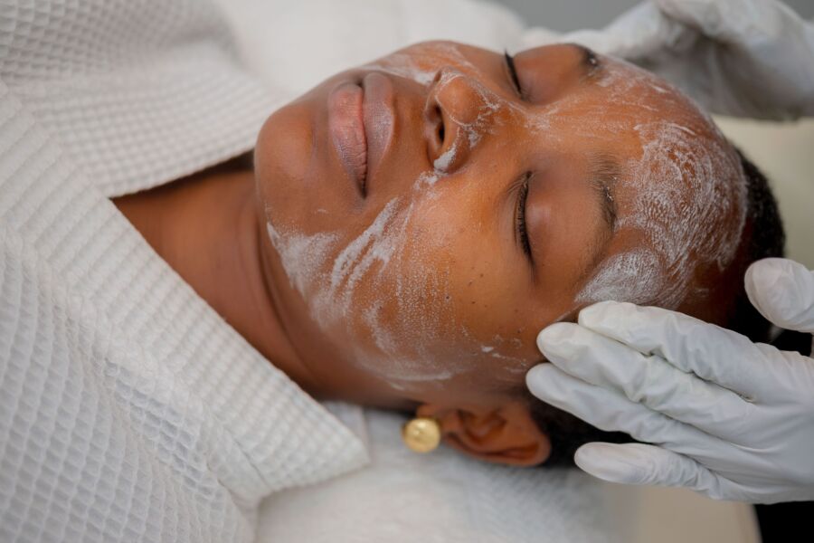 Mujer disfrutando de un relajante tratamiento facial en un spa de Abuja.